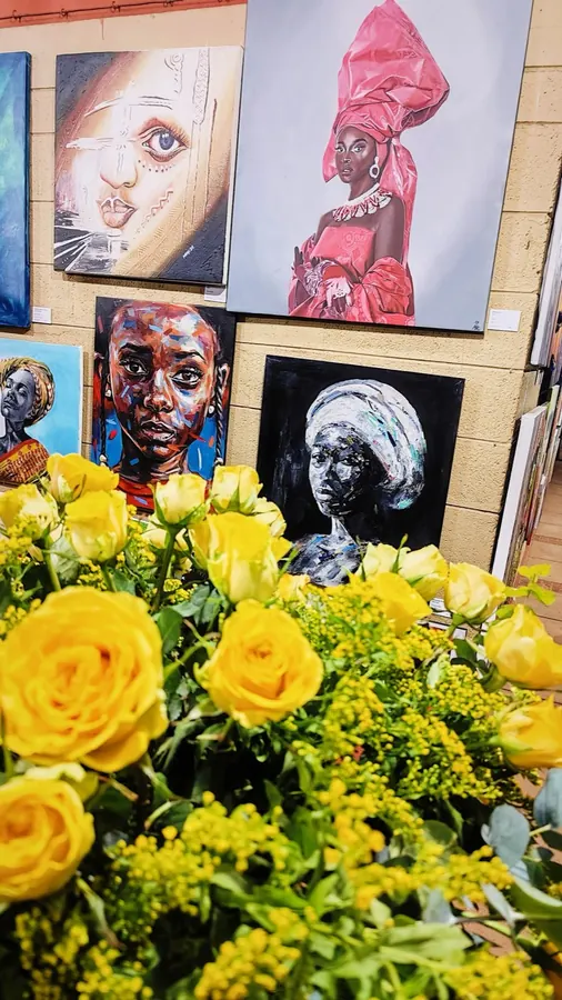 Yellow rose centerpieces at the Affordable Art Show