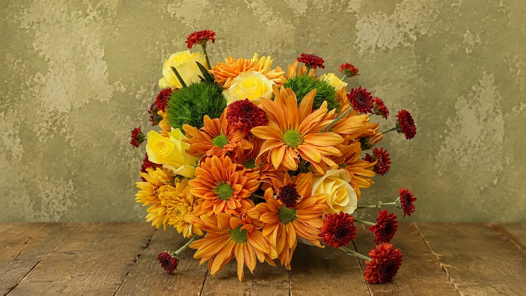 A warm arrangement of orange chrysanthemums and yellow roses